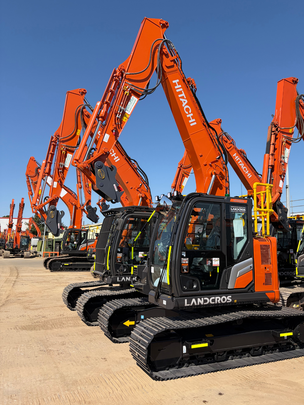 A fleet of Hitachi excavators lined up at the Synergy Hire depot, ready for plant hire and contract hire projects.